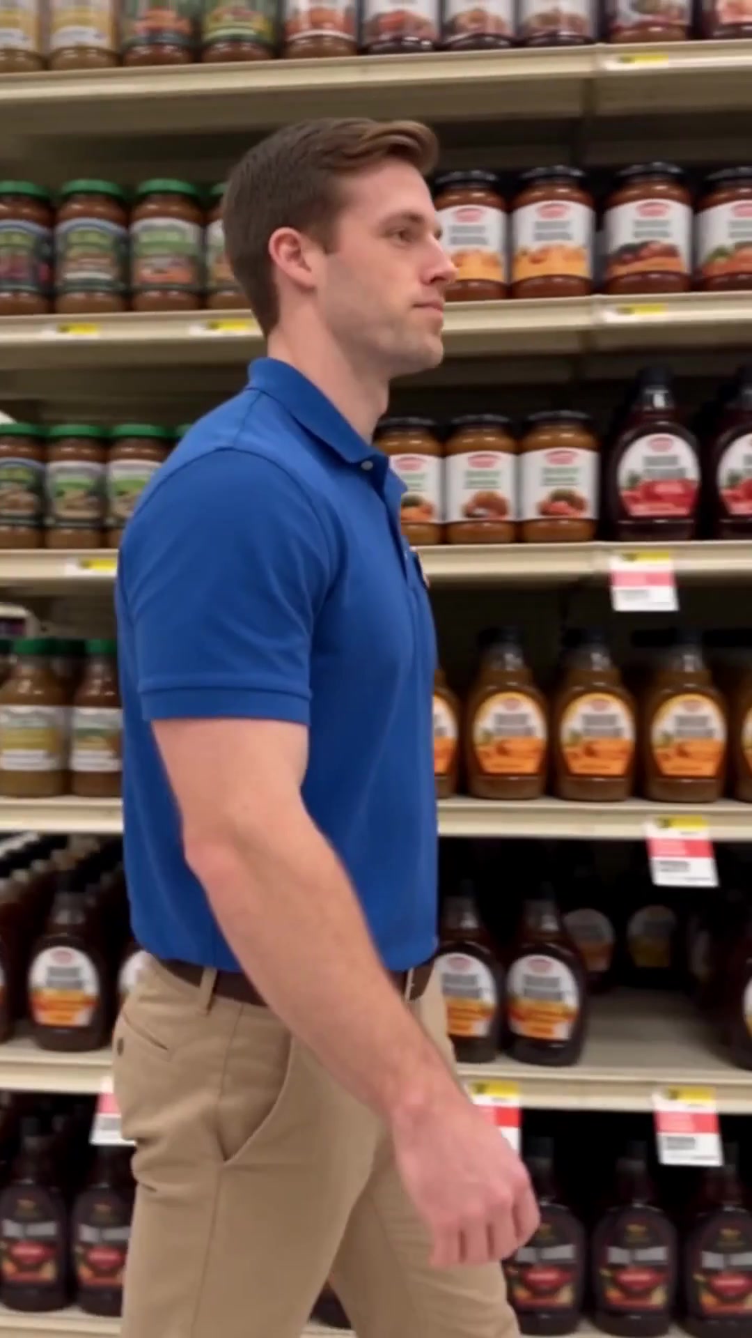A store employee walking an aisle past shelves of bottles moments before a fall - Ankin Law dramatization