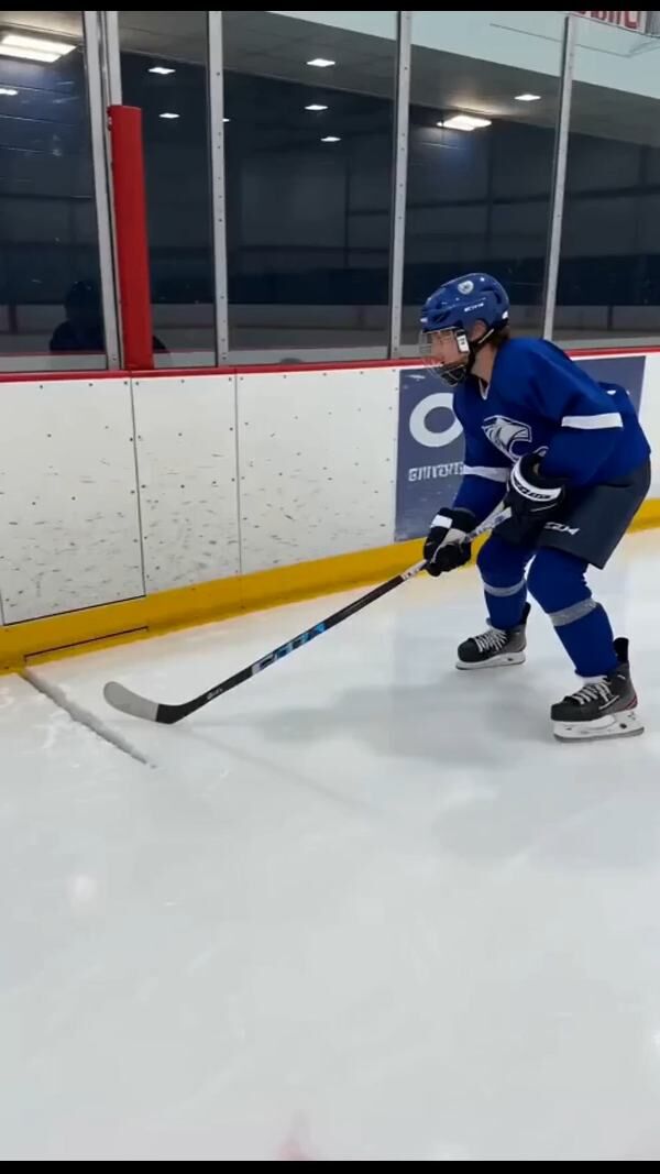 Hockey player in blue uniform skating - Ankin Law