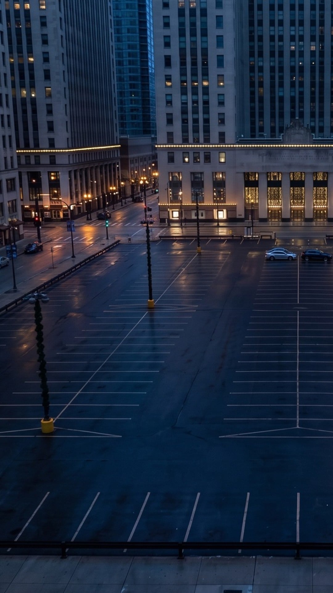 A nearly empty downtown parking lot at dusk with unlit lamp poles - Ankin Law dramatization