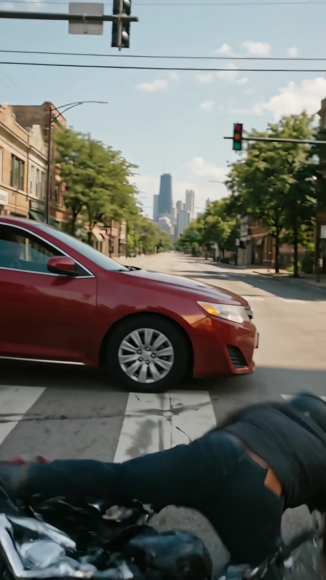 Car turning left across a motorcycle rider on a Chicago street - Ankin Law dramatization